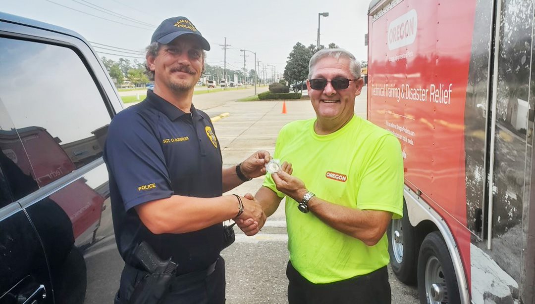 A policeman in Hammond, LA expresses his gratitude to an Oregon team member